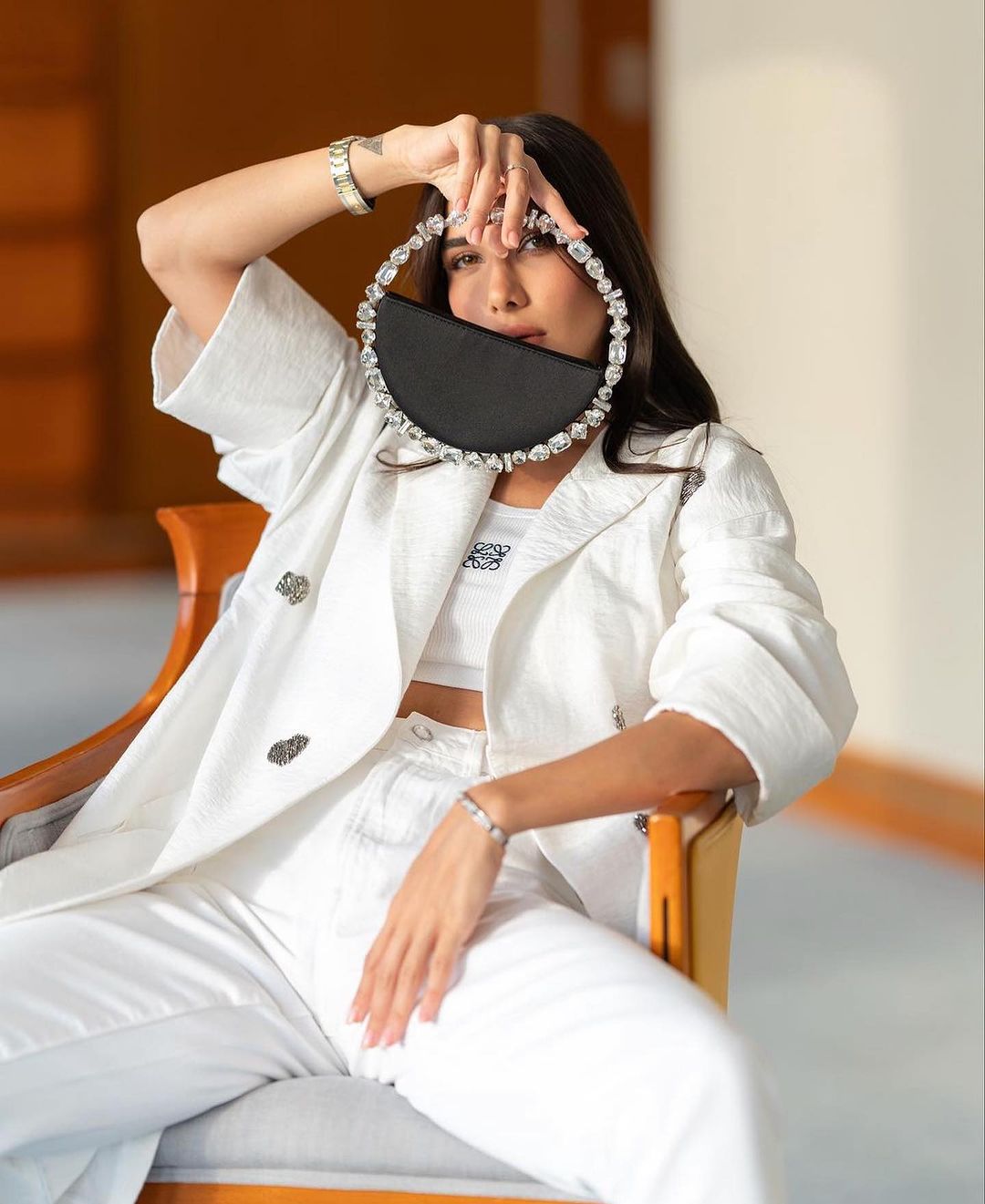 Raha Shahhatami with the Black Taliya Eternity Clutch