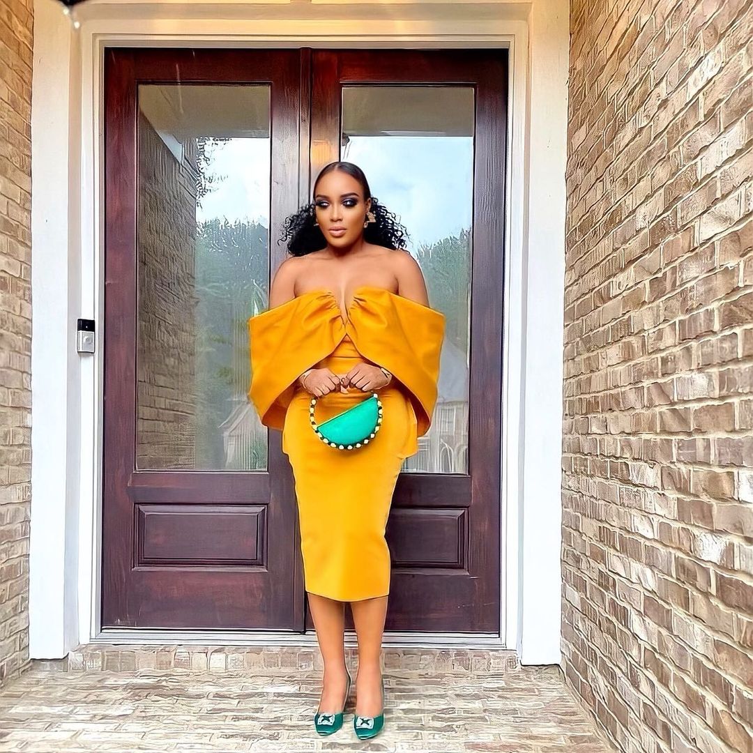 Seun Compere with Emerald Eternity Clutch